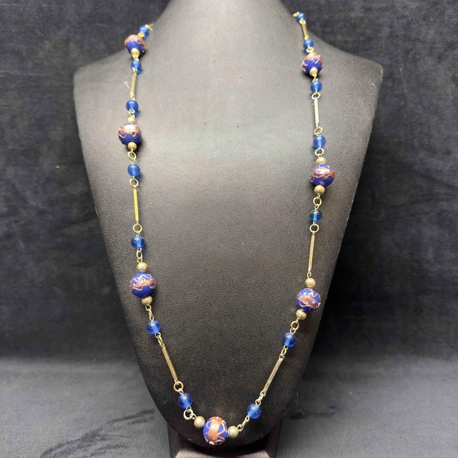 Murano Venetian Art Glass Lamp Work Bead Blue Beaded Silver Toned Chain Long Necklace C16: Murano Venetian Art Glass Lamp Work Bead Blue Beaded Silver Toned Chain Long Necklace C16. Necklace with blue colored glass beads with beautiful designs on each. The necklace features silver tone