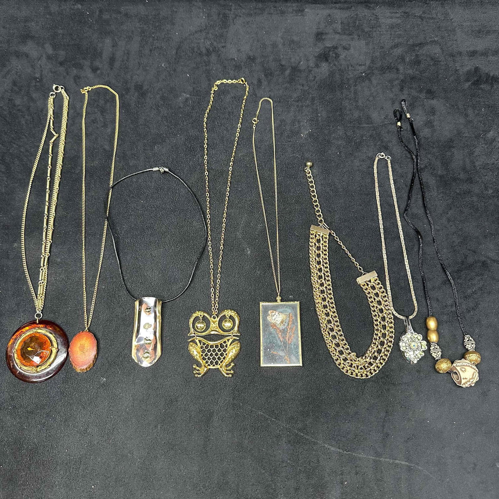 Costume Jewelry Necklace Lot Wood Owl Butterfly Pendant Multi Statement Designs: Collection of 8 vintage and costume necklaces featuring a variety of unique designs and materials. Includes a large round faux resin plastic pendant with amber-tone faux stone style, a natural wood sl