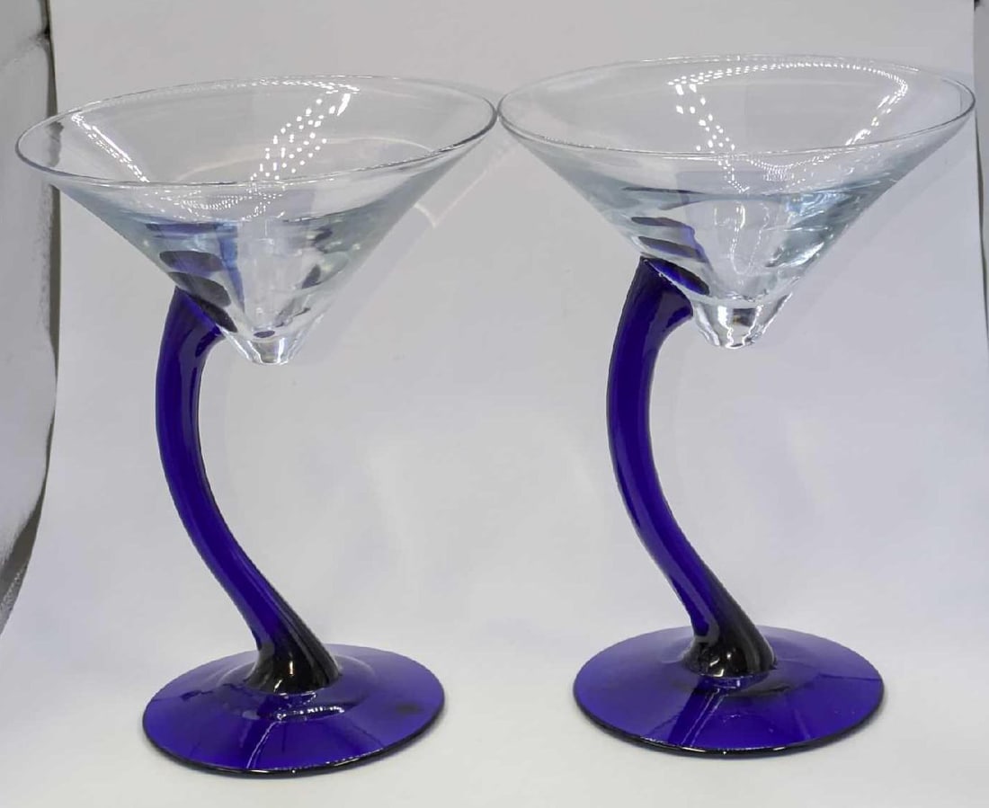 2 Cobalt Blue Stemmed Martini Glasses: 2 Cobalt Blue Stemmed Martini Glasses. The maker and date of creation is unknown. Each is approx 4 5/8" x 4 5/8" x 6 3/8" and the total weight is 0.98lb. The glasses have no chips or cracks.