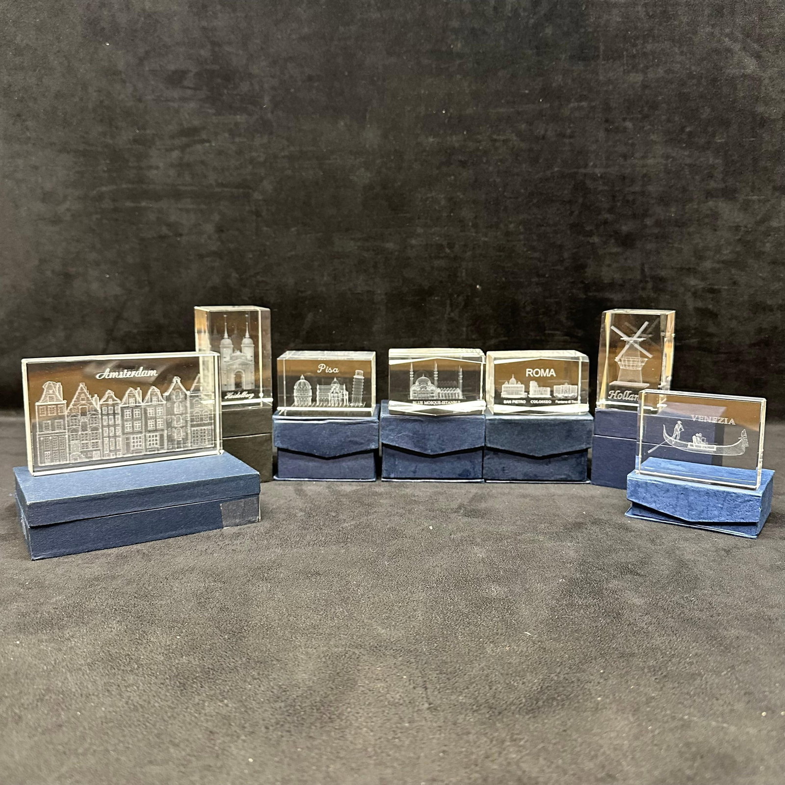 Europe Landmarks Collection of 3D Laser Engraved Crystal Souvenir Blocks: Group of clear crystal blocks with laser-engraved landmark scenes, including Amsterdam, Pisa, Rome, Venice, Holland, Heidelberg, and Istanbul. Each glass art piece comes with its original box. T
