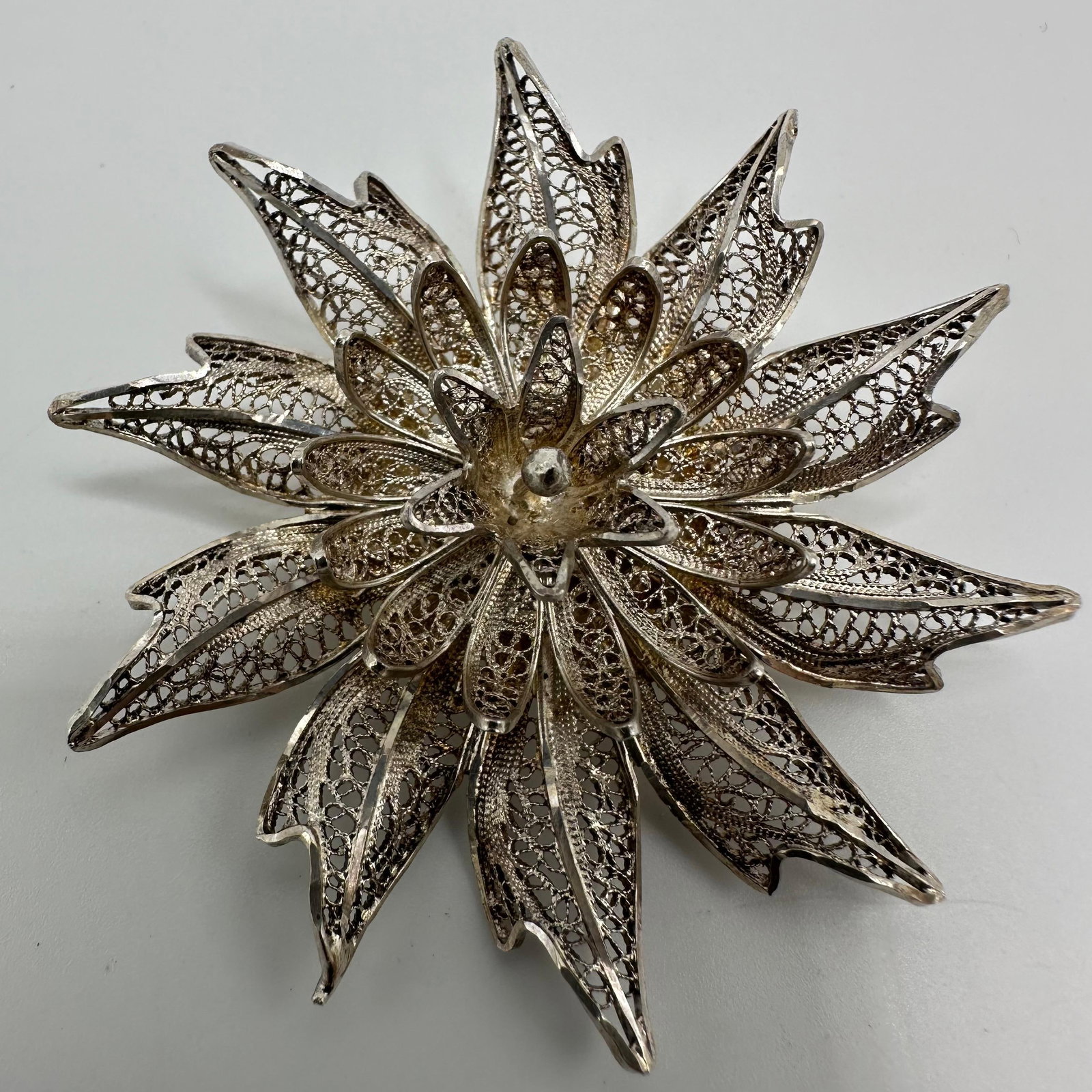 Filigree Flower Silver Brooch Lace Style Silverwork: This item is in good pre-owned, previously used/displayed condition with noticeable light wear and surface scratches. Please reference all photos for full details. This piece of jewelry has been