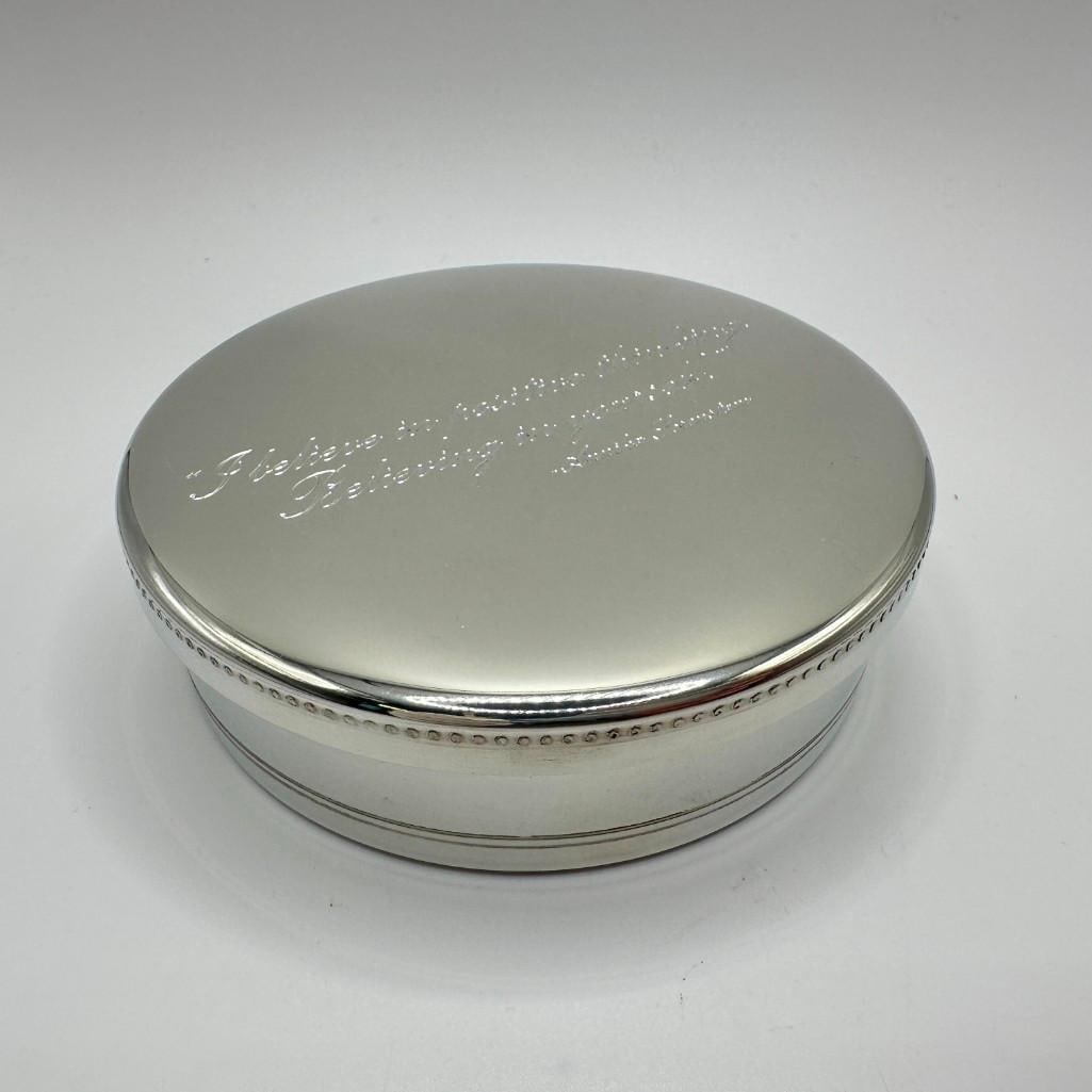 Tiffany and Co. Pewter Quote Trinket Box: Handcrafted by Tiffany & Co., this round pewter trinket box features a beaded edge design and an engraved quote on the lid from Annika Sorenstam: "I believe in positive thinking. Believing in