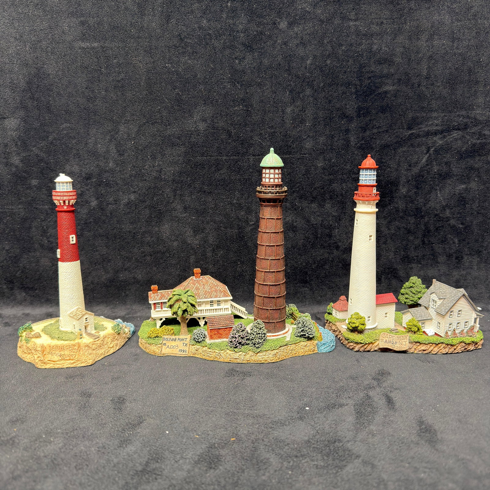 Three Harbour Lights New Jersey Lighthouse Figurines Cape May Barnegat Bolivar Point: Lot of three Harbour Lights New Jersey lighthouse figurines, including Barnegat #414, Bolivar Point #422 (signed), and Cape May #428. Includes original boxes and certificates/paperwork as shown. Pre-o