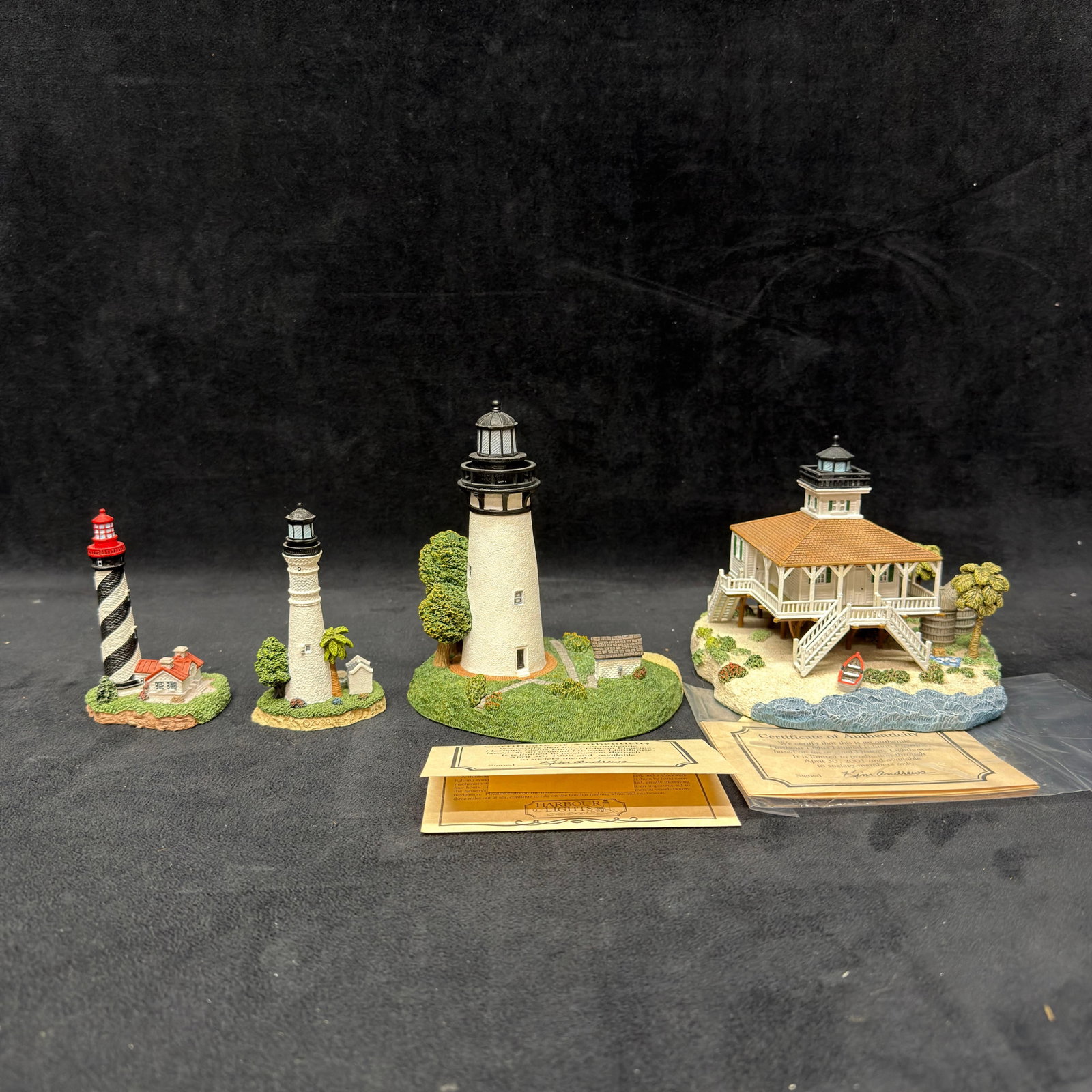 Four Florida Harbour Lights Lighthouse Landmark Figurines Signed Collectibles: Group of four Florida lighthouse collectibles, including Harbour Lights Society Exclusive Amelia Island #505, Society Exclusive Boca Grande #531, plus This Little Light of Mine St. Augustine #121 and 
