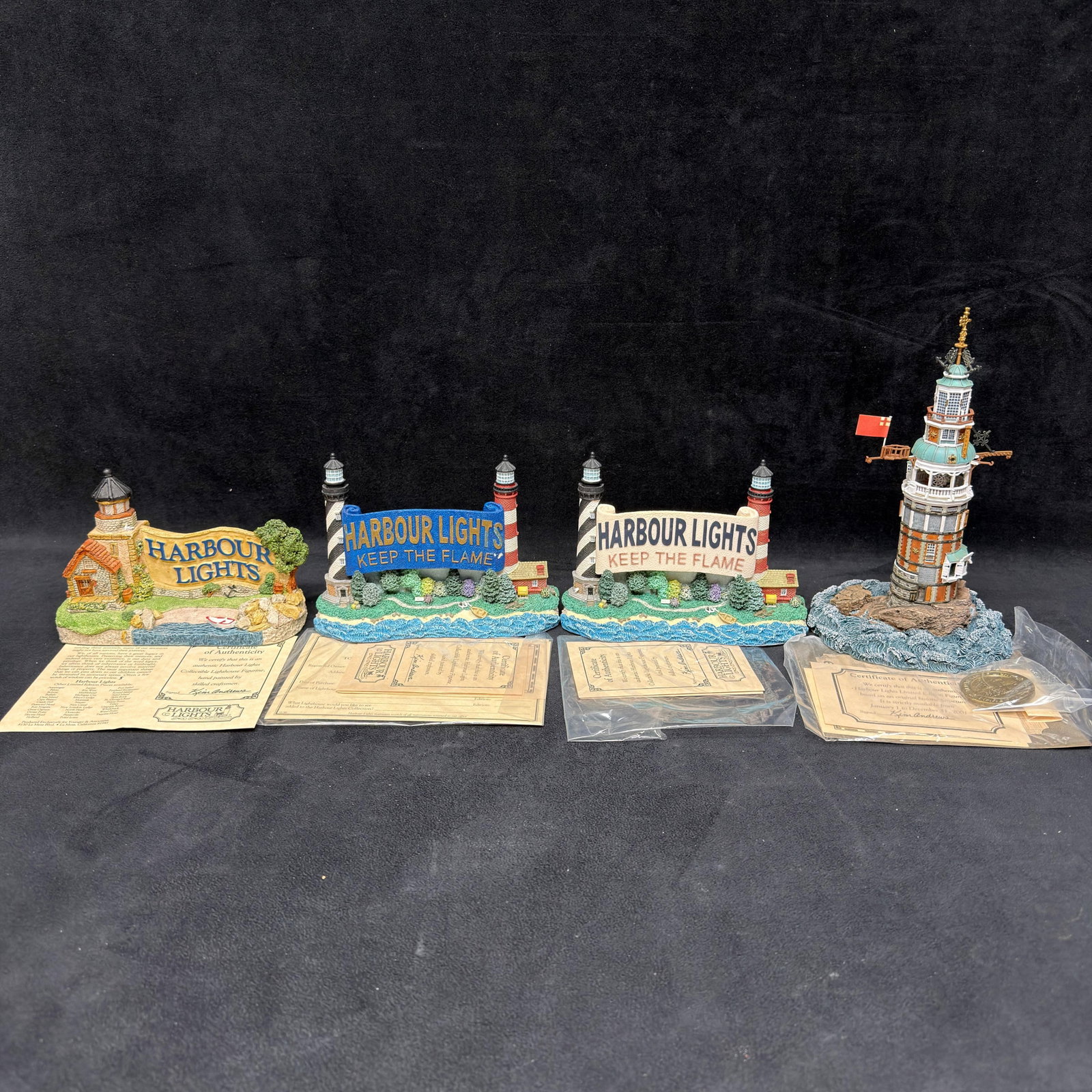 4 Harbour Lights Lighthouse Collectibles Special Event and Anniversary Editions: Group of four Harbour Lights collectibles, including Legacy Lighthouse #690, two Beckoning Beacons special event exclusives HL628 and HL630, and a 10th Anniversary “Ten Years of Light – A 