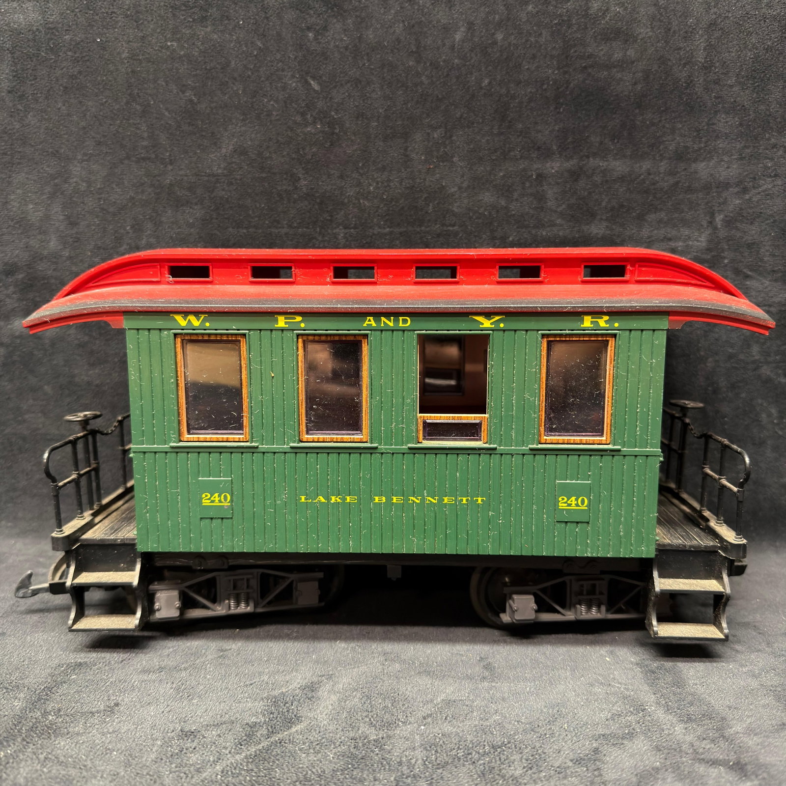 LGB W.P. and Y.R. Lake Bennett #240 G Scale Passenger Car: LGB G scale White Pass and Yukon Route Lake Bennett passenger car #240. Green body with red clerestory roof, gold lettering, and detailed end platforms, railings, and trucks. Marked LGB and Made in We