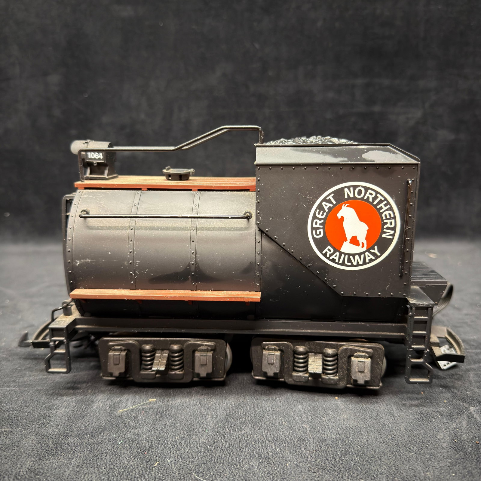 LGB 22232 Great Northern #1064 G Scale Vanderbilt Tender: LGB 22232 Great Northern Railway #1064 G scale Vanderbilt-style tender featuring Great Northern mountain goat logos, simulated coal load, wood-look walkways, rear light, and metal wheels. Made in Germ