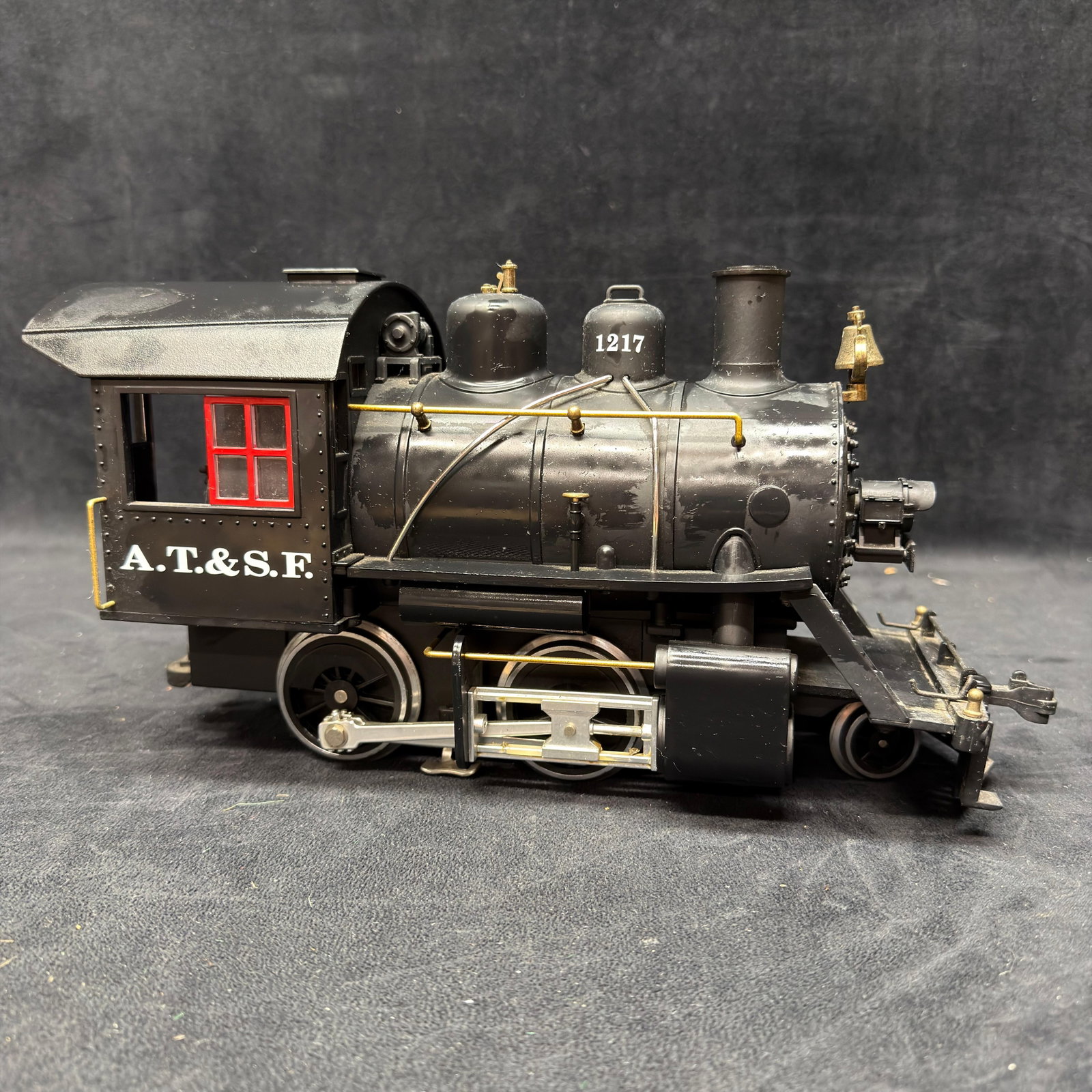 LGB Santa Fe A.T. and S.F. No. 1217 G Scale Steam Locomotive Train Collectible: LGB G scale A.T. and S.F. Santa Fe steam locomotive No. 1217, finished in black with red cab windows and brass-tone details. Features detailed running gear, headlight, bell, cab interior, an