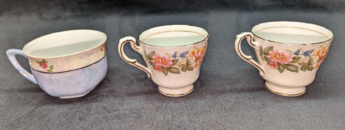 3 Fine China Paragon & German Tea Cups: 3 Fine China Paragon & German Tea Cups. This lot contains: (2) Paragon Fine Bone China "Country Lane" Tea Cups. Each is approx 3 3/4" x 2 7/8" x 2 1/2". (1) German China Floral