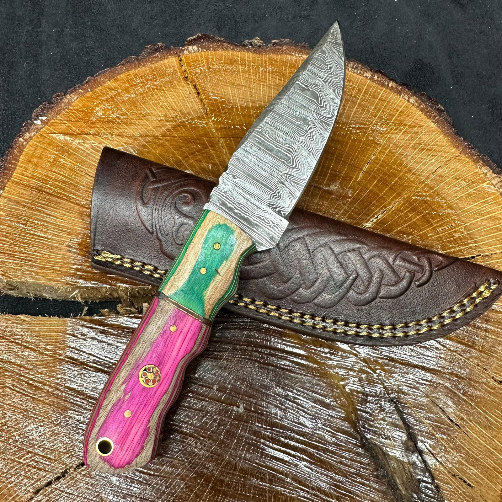 Two Tone Colorway Handle MHS Cutlery Knife Drop Point Blade Q13: Fixed blade knife by MHS Cutlery featuring a layered patterned steel blade and decorative spine work. The handle has a contoured, multi-colored wood/epoxy resin-style grip with metal mosaic pin accent