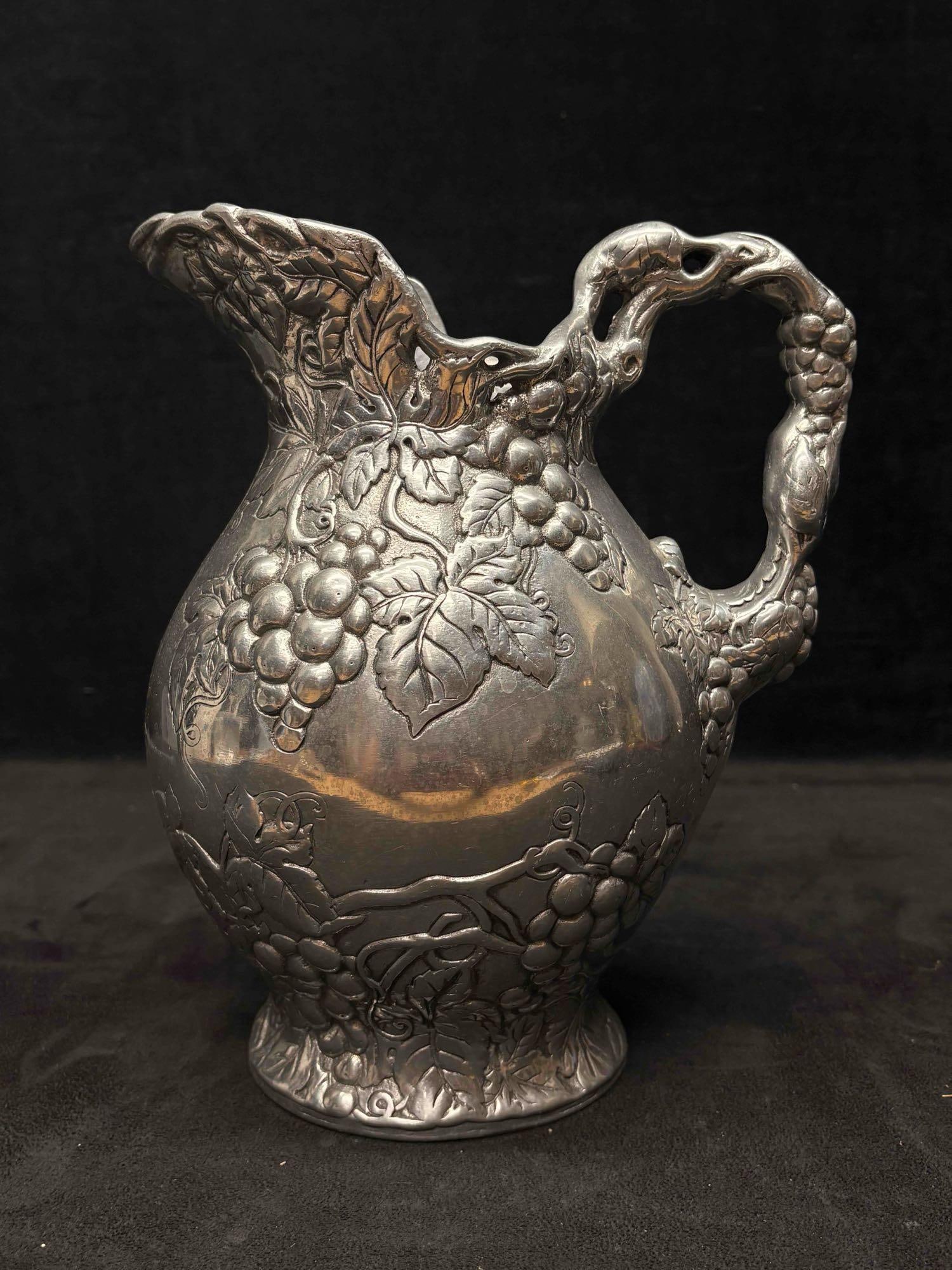 1990s Arthur Court Silver 2qt Grape Pitcher: This beautiful silver pitcher is an Arthur Court piece; an aluminum cast sculpted vintage and pre-owned collectible. Making each pitcher slightly unique from the others like it. The conditions can be 