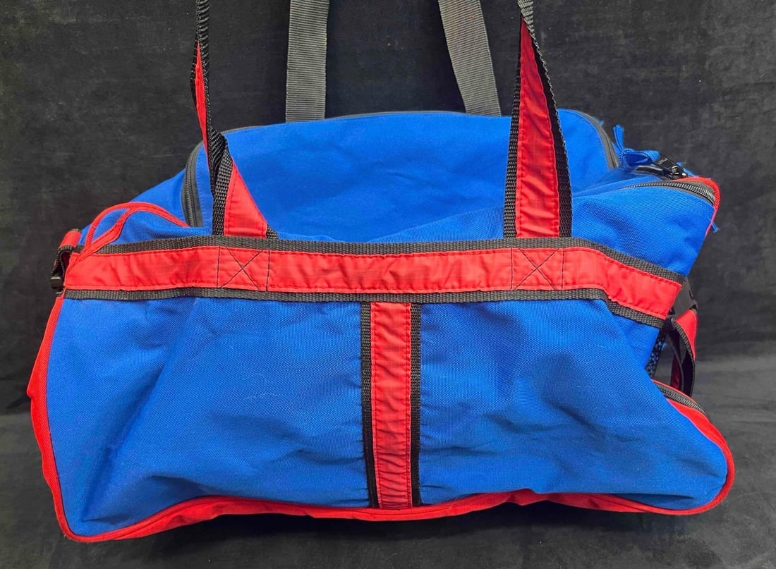 Vintage Legends Blue And Red Duffle Bag: This lot contains Vintage Legends Blue And Red Duffle Bag. It is approx 20" x 10 1/2" x 3". Total weight is approx 1.5lbs. Overall the duffle bag is in good pre owned condition with no major flaw