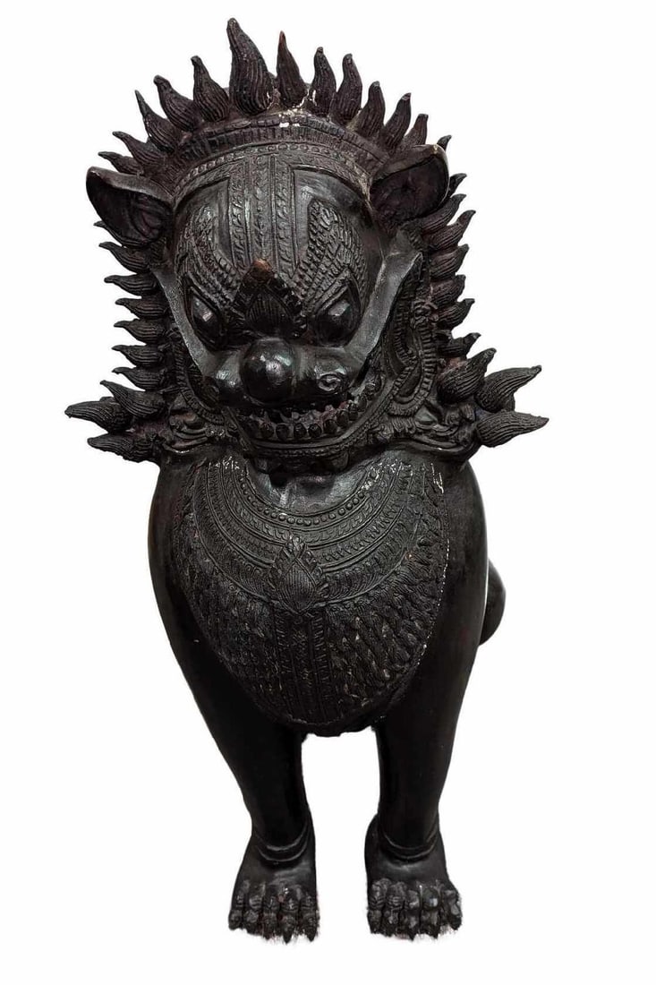 Large Bronze Khmer Style Foo Dog Statue B: Large Bronze Khmer Style Foo Dog Statue B. Is approx 15" x 17" x 40" and it weighs 148.50 lbs. Is in a good, vintage condition with some wear, chips, and color loss on the patina. Khmer-style guardian