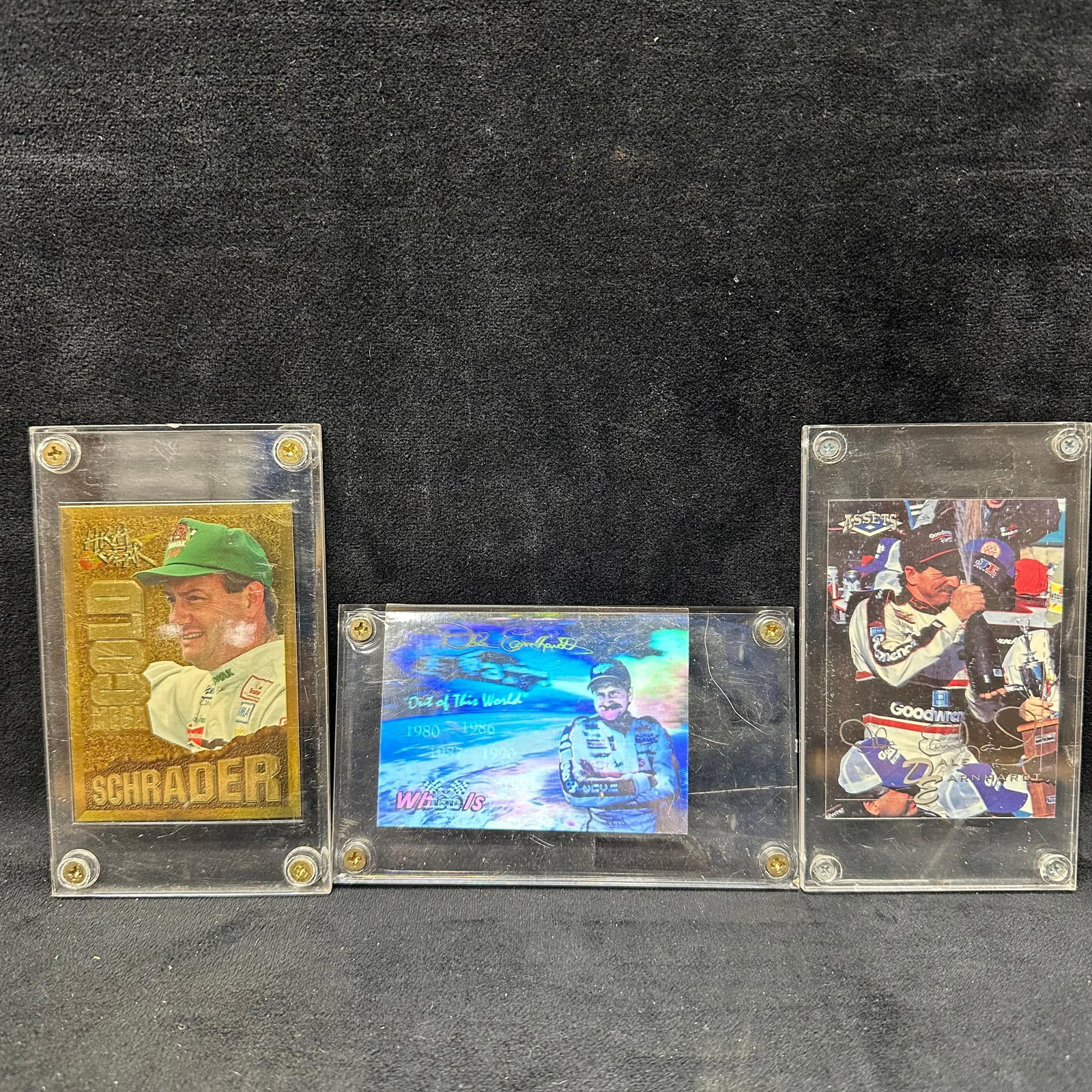Ken Schrader and Dale Earnhardt Sr. NASCAR Trading Card Lot High Gear Wheels and Assets Inserts: Three-card NASCAR driver insert lot housed in screw-down display holders. Includes: Ken Schrader Gold-Tone High Gear Insert. Gold foil style insert featuring Kodak Chevrolet branding. Dale Earnhardt S