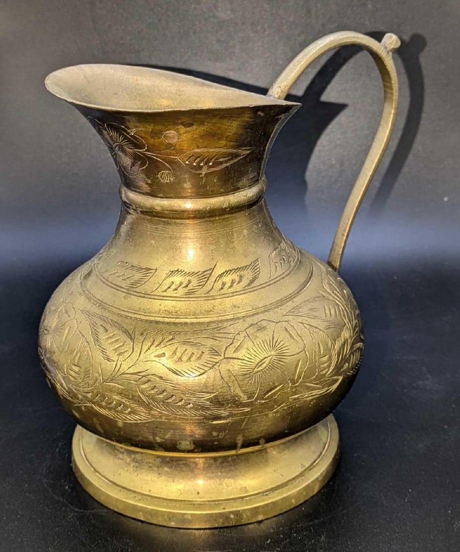 Vintage Etched Brass 5" Pitcher: Vintage Etched Brass 5" Pitcher. The maker and date of creation is unknown. This is approx 6 1/2" x 4 1/2" x 5 3/4" and it weighs 1.22lb. There is some tarnish and a dent on the bottom. Please see the