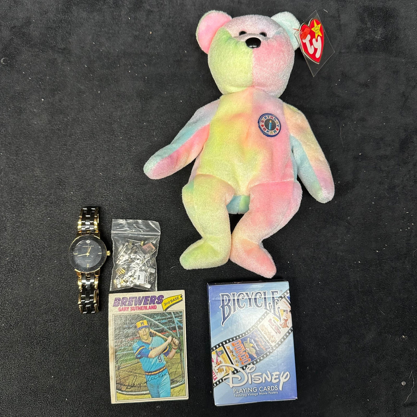 Mixed Collectibles Lot Ty Beanie Baby Anne Klein Watch Disney Cards and Brewers Card: Mixed lot of assorted collectibles, including a Ty Beanie Baby Birthday Bear plush with tag, an Anne Klein quartz wristwatch with additional spare links, a deck of Bicycle Disney playing cards, and a 