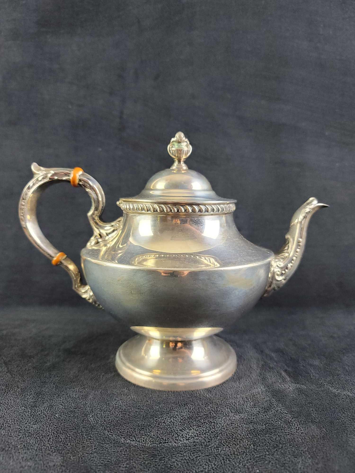Antique Sterling by Poole 1027 Georgian Tea Pot: Antique Sterling by Poole 1027 "Georgian" is stamped by maker on the bottom. Has a nice gadroon pattern around rim. Hinged lid functions properly. In good condition, needs polishing.
