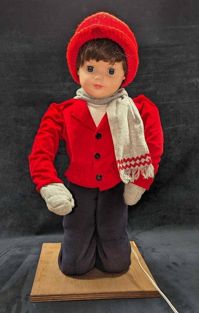Animated Little Girl In Winter Clothing Figure: Animated Little Girl In Winter Clothing Figure. When plugged in, the little girl's right arm moves up and down. There might have been something that the figure moved at one time, but it is no longer