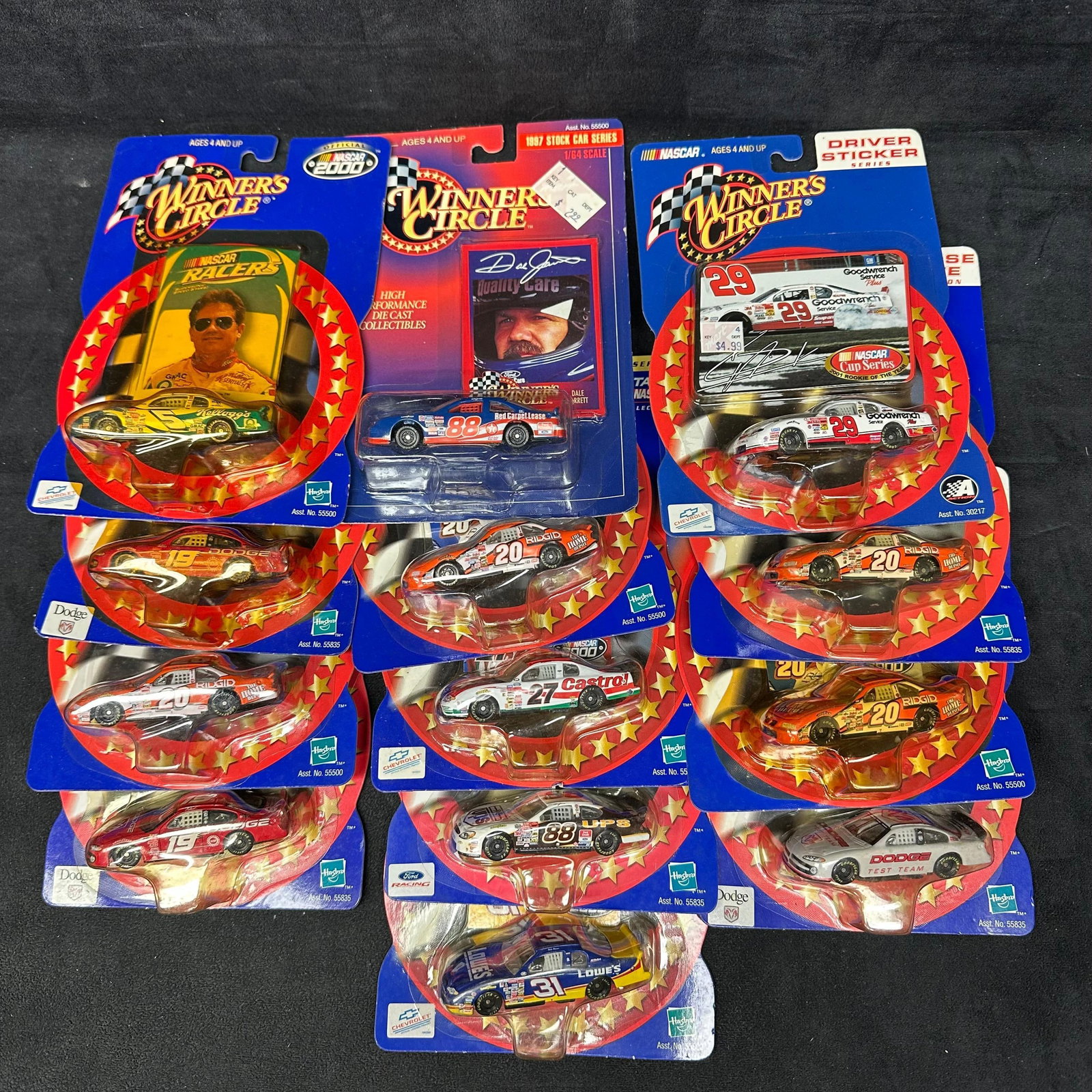 Group of Thirteen Winners Circle NASCAR Diecast Cars in Original Packaging: Group of 13 Winners Circle NASCAR diecast cars in original card packaging. Includes various drivers and sponsors such as Dale Jarrett #88, Kevin Harvick #29, Tony Stewart #20, Casey Atwood #19, M
