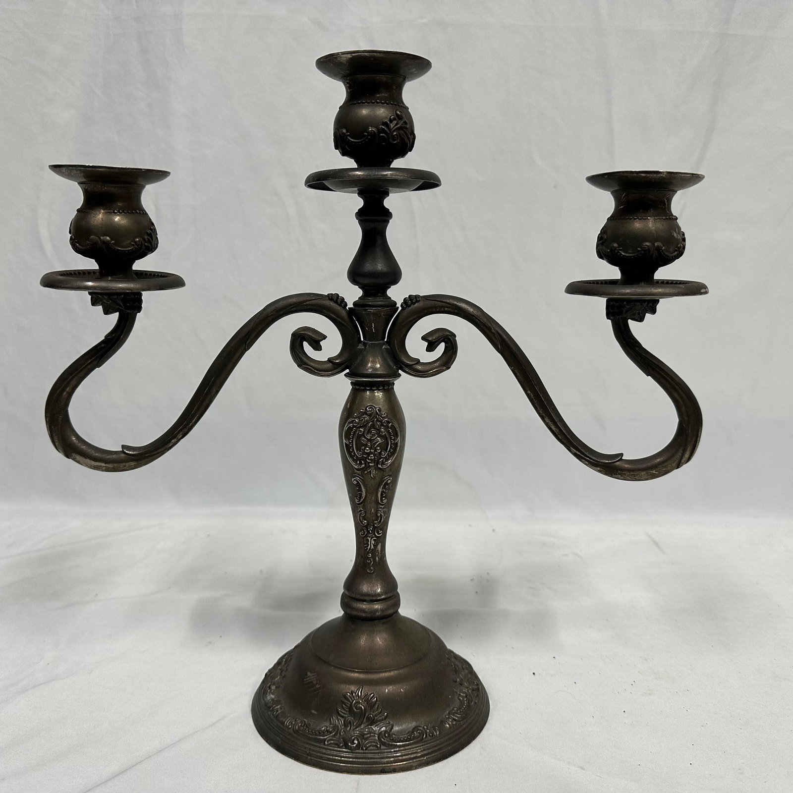 Three-Light Silverplate Metal Candelabra Table Candlestick Baroque Style: Vintage three-light silver plate metal candelabra with ornate scrolling arms and decorative base. This item is in pre-owned, heavily used, previously displayed condition with noticeable light wear