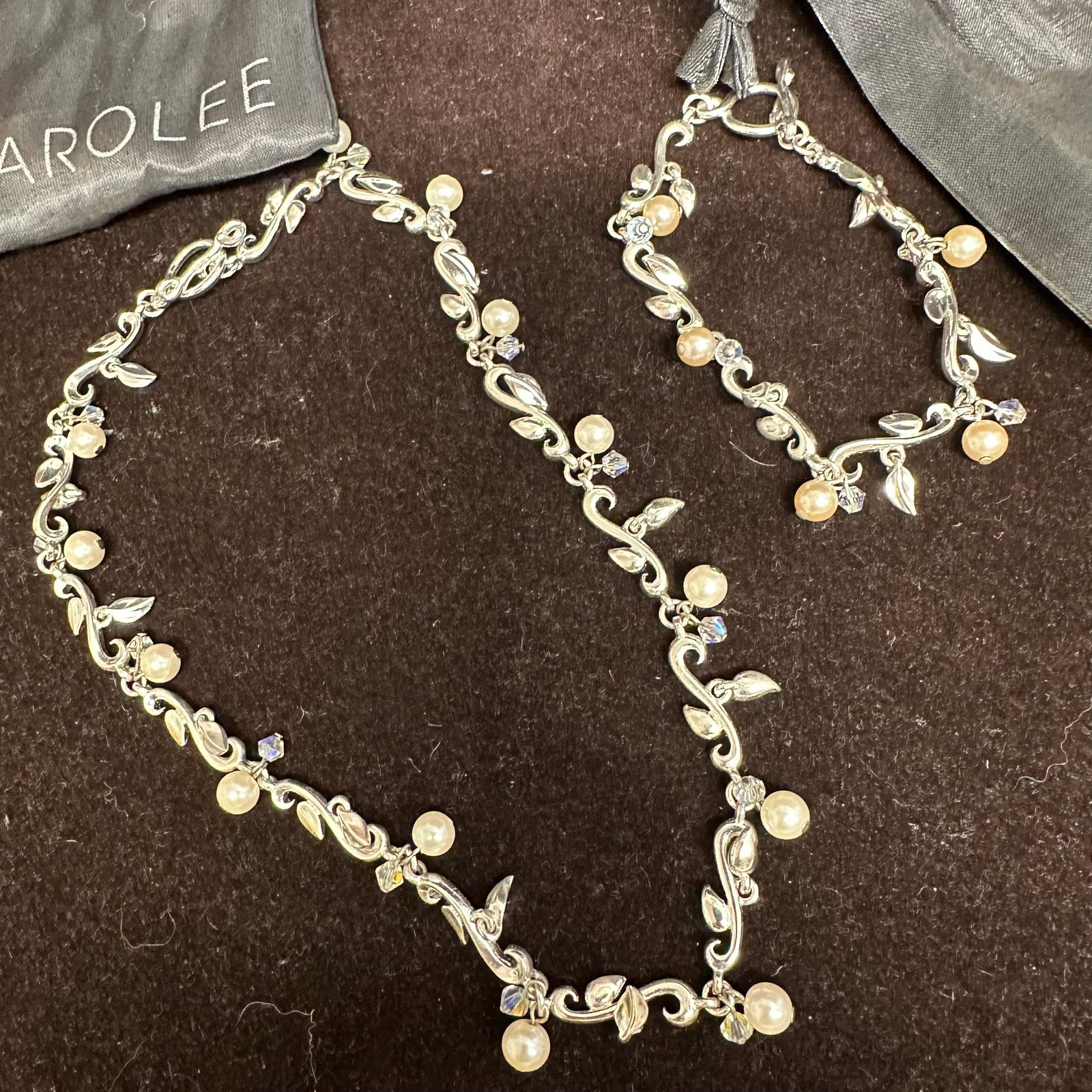 Carolee Silver Plated Floral Faux Pearl Design Necklace and Bracelet Set: Each piece includes a Carolee dust jacket bag. These items are in pre-owned, previously displayed condition with light wear and surface markings. Please reference all photos for full details. Necklace