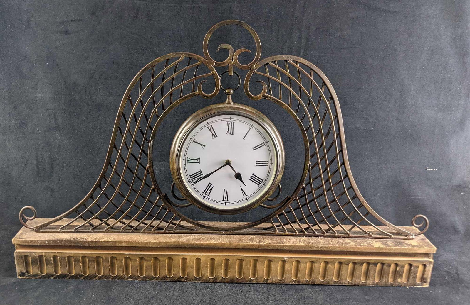 Vintage Style Prestige Metal & Wooden Mantel Clock: Vintage Style Prestige Metal & Wooden Mantel Clock. Requires one AA battery. The clock is approx 34" x 3 1/2" x 21 1/2" and it weighs 15lbs. The clock is in a good, used condition with some wear.