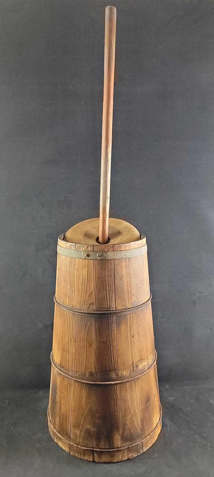 Antique Wooden Butter Churn: The maker and date of this wooden butter churn are unknown. However, the wood is aged and worn in areas of use. There are no markings on the piece. It is in good used condition and still has a tight