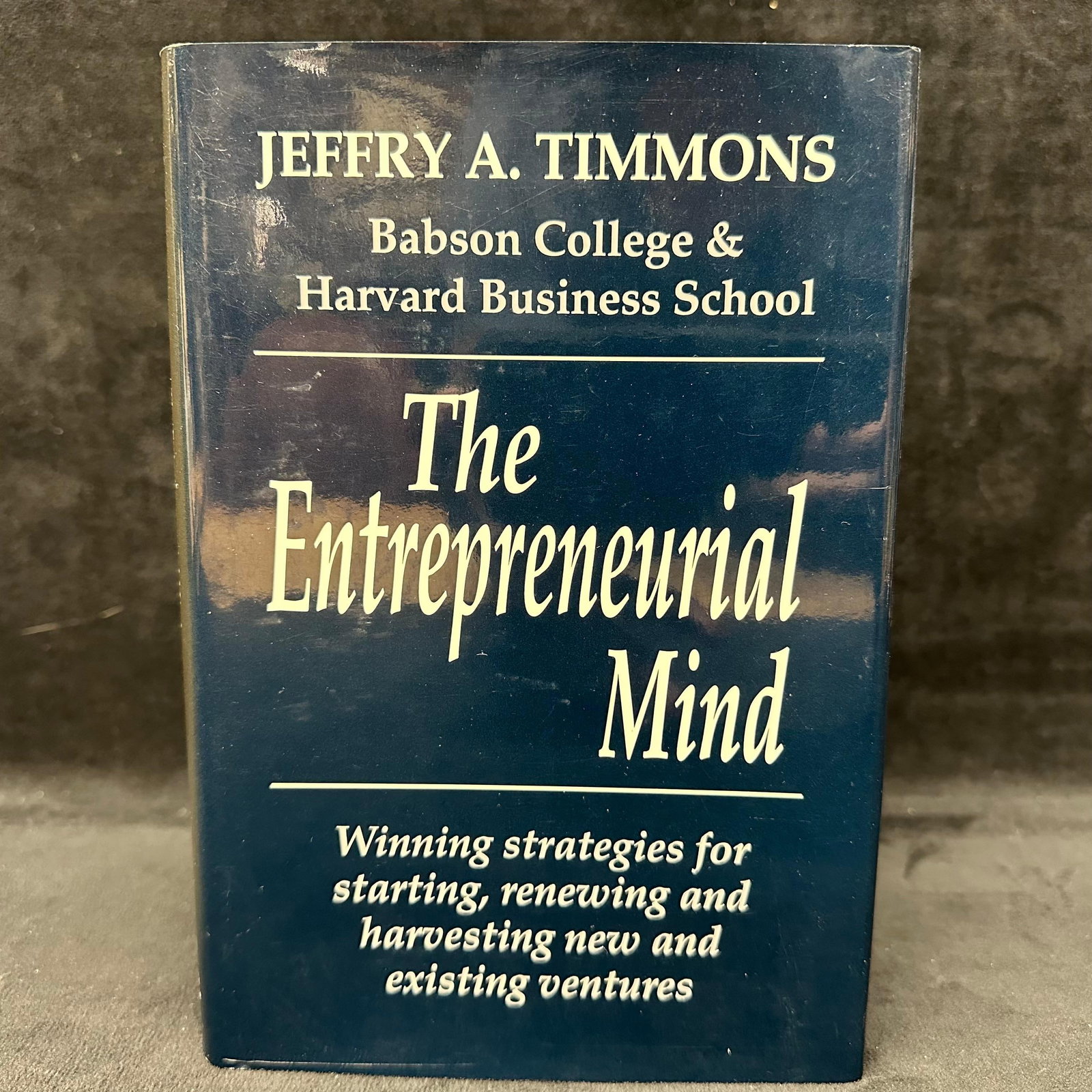 The Entrepreneurial Mind Hardcover Book Signed: Signed with a personal inscription to Michel Roux. Condition shows general handling wear, scuffing, and surface marks to the cover consistent with age. Interior pages appear intact. Includes dust jack
