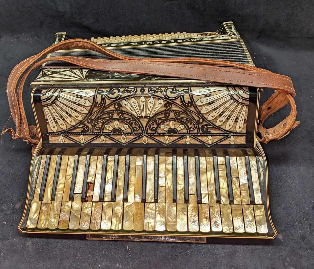 Vintage Moreschi & Sons Accordion With Case: Vintage Moreschi & Sons Accordion With Case. Is (with case) 20 3/4" x 9 1/2" x 17" and it weighs 29.30lbs. The case has heavy wear and the accordion's keys are broken/missing the covering. Is untested