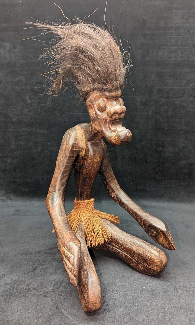 Primitive Carved Wood Tribal Man Statue: Primitive Carved Wood Tribal Man Statue. The maker and date of creation are unknown. This is approx 8 1/4" x 8" x 17 1/2" and it weighs 2.29lb. Has some light wear and some residue in the 'hair'.