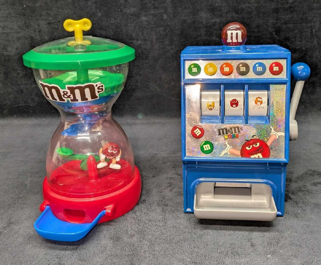 M&M Candy Dispenser Fun Machine And Slot Machine: M&M Candy Dispenser Fun Machine And Slot Machine. This lot includes: (1) M&M's World Slot Machine/Candy Dispenser. This is approx 5 3/4" x 5 1/4" x 9". The machine was tested