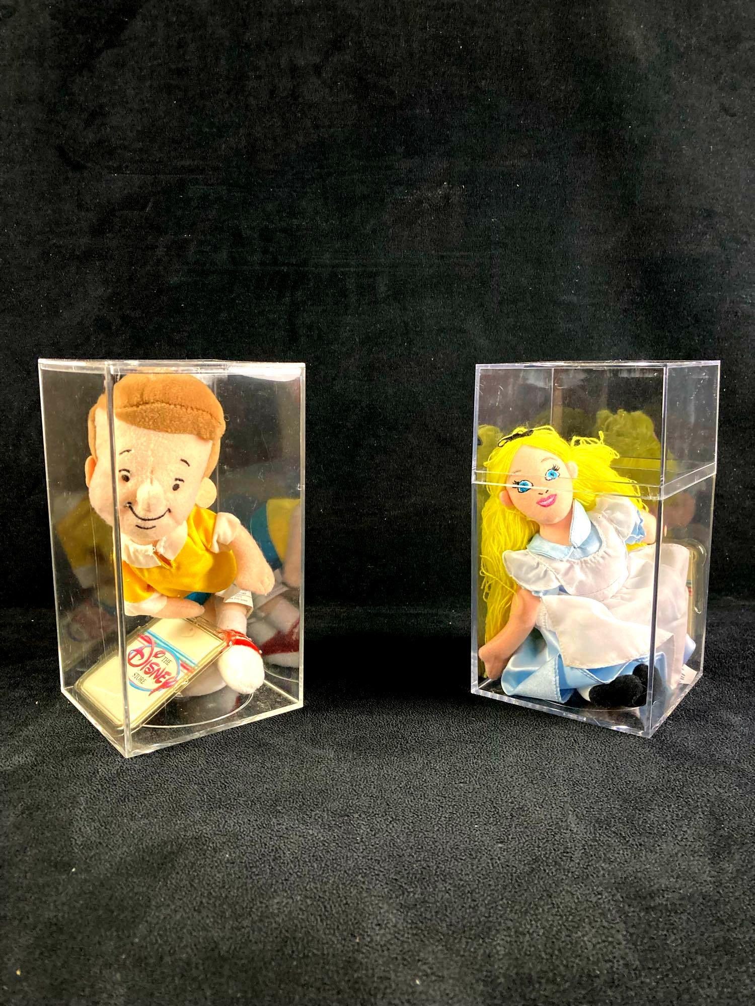 Set of (2) Disney Plush Bean Bag Dolls: Up for auction is a recent estate find, a set of two Disney bean pag plush dolls in collector's cases. One is Christopher Robin from Winnie the Pooh and the other is Alice from Alice in