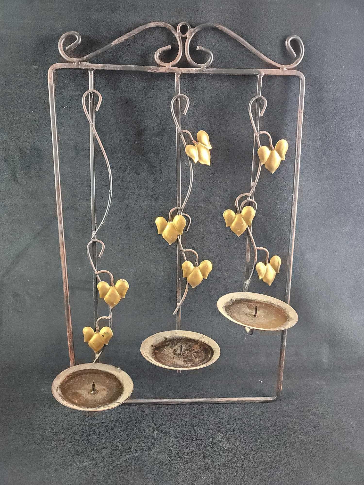 Metal 3 Tier Candle Wall Mount: Metal 3 candle wall mount. The candle mounts are staggard in upward direction from left to right. The wire art looks like vines creeping toward the candles with gold tone painted leaves. Great