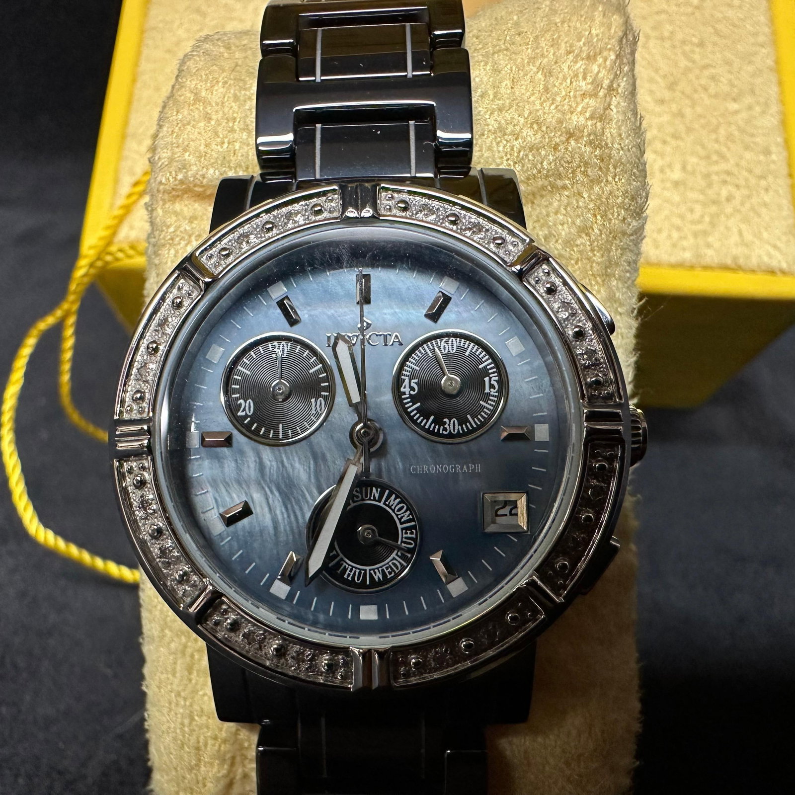 Invicta Ceramics LadyModel 0728 Ladies Watch Quartz Chronograph Wristwatch: Invicta chronograph wristwatch featuring a blue sunburst dial with three subdials, a date window, and a crystal-accented bezel. Stainless steel case with black toned stainless steel link bracelet
