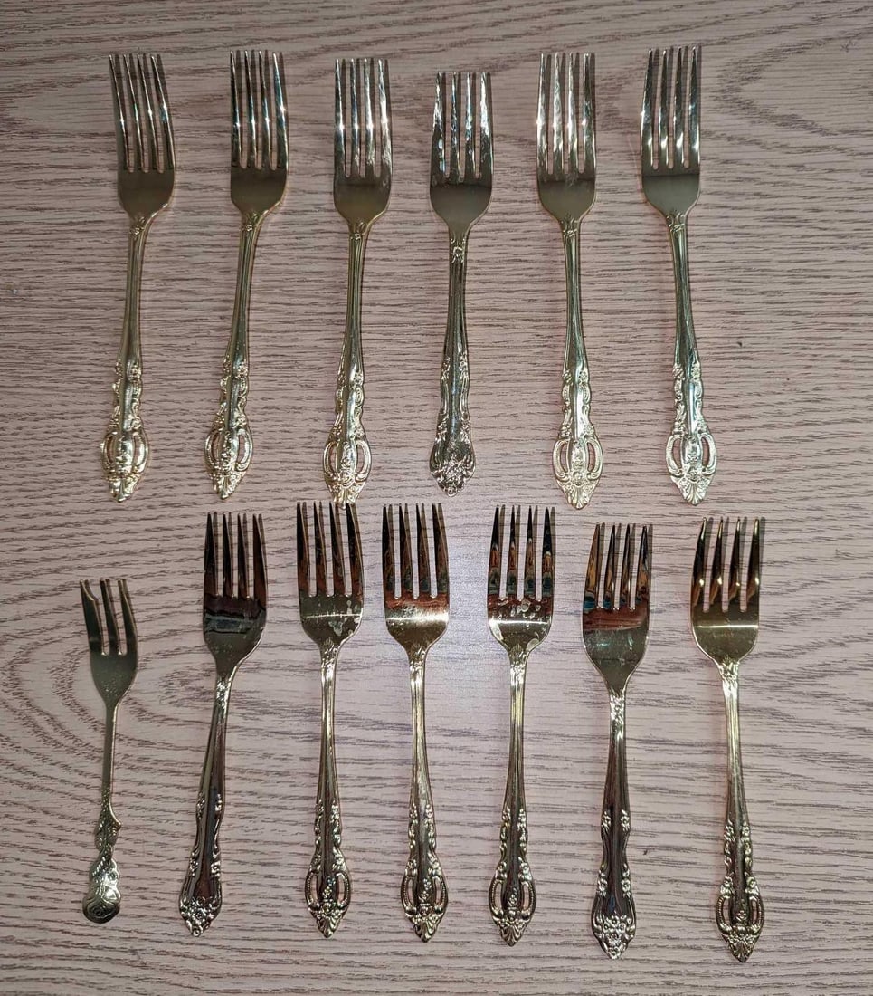 13 Vintage Gold Plated Seafood Forks: This lot includes: (6) Estia Dinner Forks. Each is approx 7 1/4". (6) Estia Salad Forks. Each is approx 6 1/2". (1) Vintage Gold Plated Seafood Fork. This is approx 5". Unknow