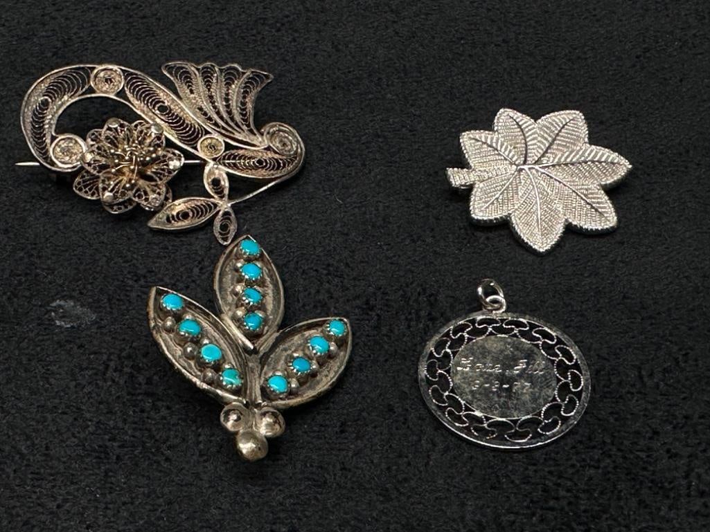 Mixed Silver Pin & Charm Lot: Mixed Silver Pin & Charm Lot Lot of four pieces; 3 pins and one charm. The oak leaf and charm are marked sterling; the flower and turquoise leaf pin are not marked but test as silver. Approximate 