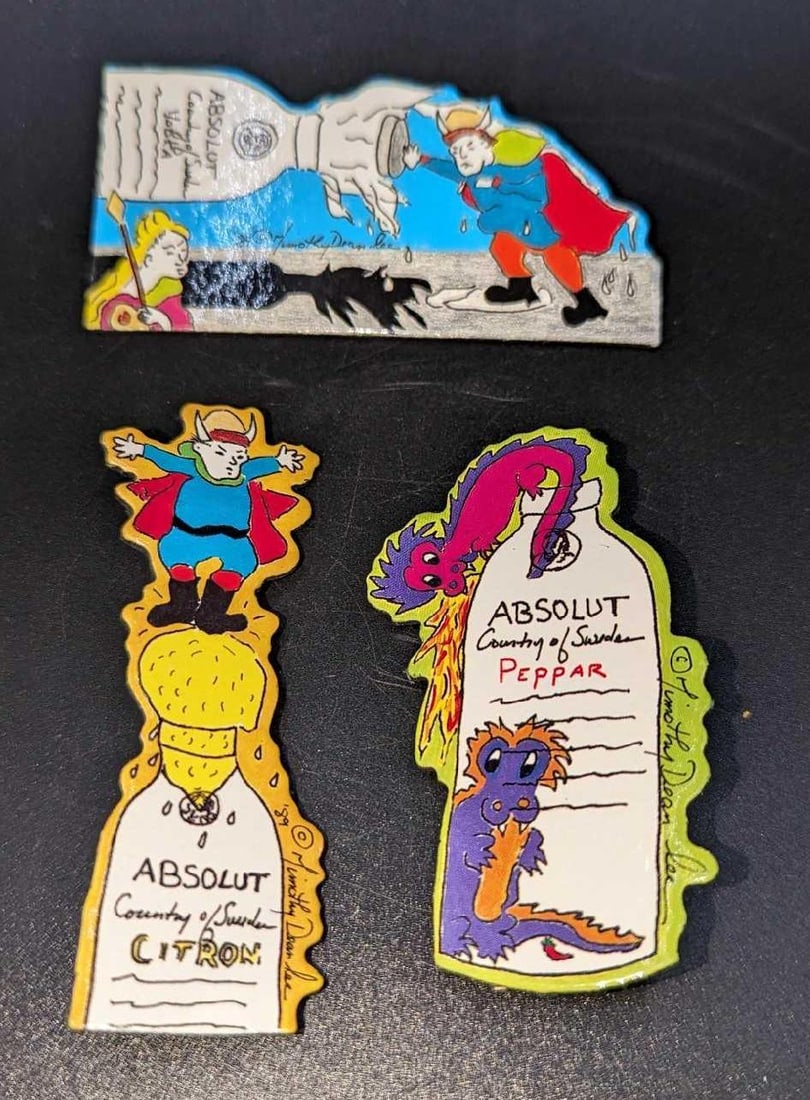 3 Absolut Vodka Peppar Advertising Art Pins / Brooches C: 3 Absolut Vodka Peppar Advertising Art Pins / Brooches C. By Timothy Dean Lee. Each is made of a Laminated Art Board. This was released from the year 1990 to the year 1991. The set is approx 1 5/8"x 1