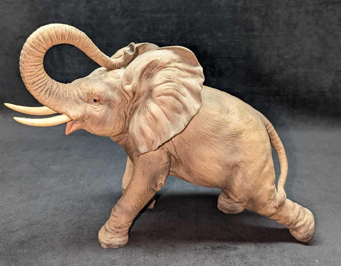Andrea By Sadek Large Ceramic Trunk Up Elephant: Andrea By Sadek Large Ceramic Trunk Up Elephant. #7777. This is approx 14" x 6" x 10" and it weighs 4.30 lbs. There are some markings on the tusks and small scratches on the body. There are no cracks 