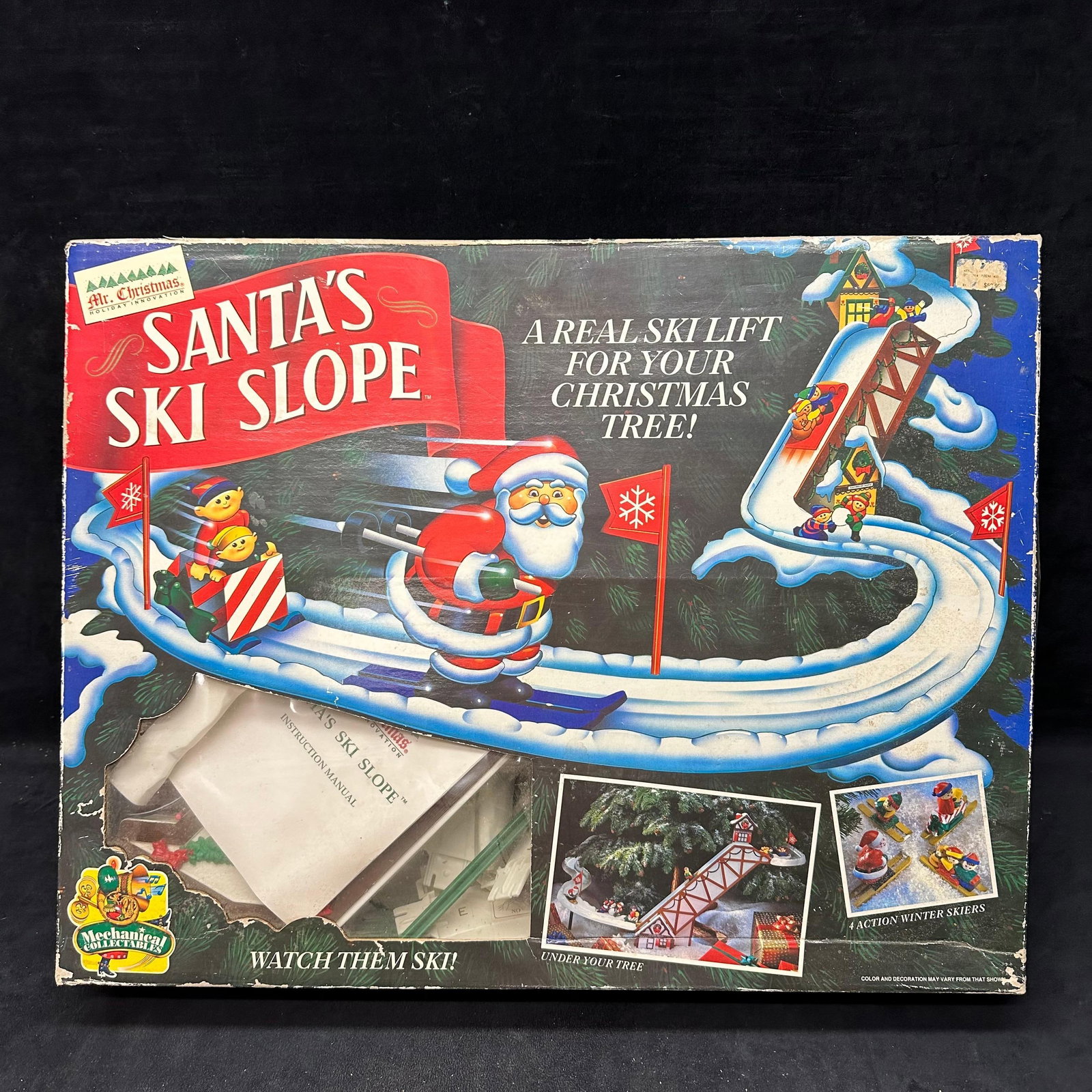 Mr. Christmas Santa's Ski Slope Animated Ski Lift Holiday Track Set: Mr. Christmas “Santa’s Ski Slope” animated ski lift set. Includes track pieces, skiers, chalets, power adapter, posts, hardware, and original instruction manual. The box shows