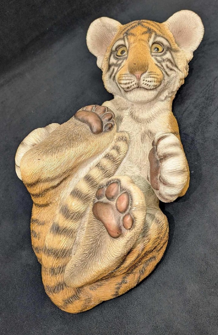 Sandra Brue Sandicast Tiger Cub Sculpture With Glass Eyes: Sandra Brue Sandicast Tiger Cub Sculpture With Glass Eyes. This adorable life-like tiger cub is approx 7 3/4" x 16" x 8" and it weighs 16.20lbs. The sculpture has some color loss, markings and small w
