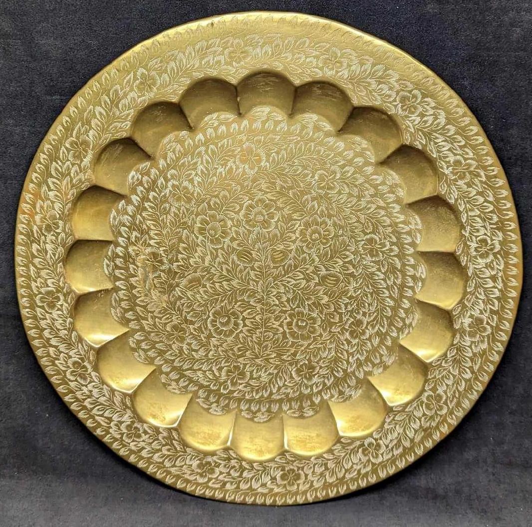 Vintage World Gift Brass Serving Tray: Vintage World Gift Brass Serving Tray. With a floral design. Is approx 17 1/4" x 17 1/4" x 1" and it weighs 2.3lbs. The tray also has a hook on the back to be hung. the tray has some markings and scra