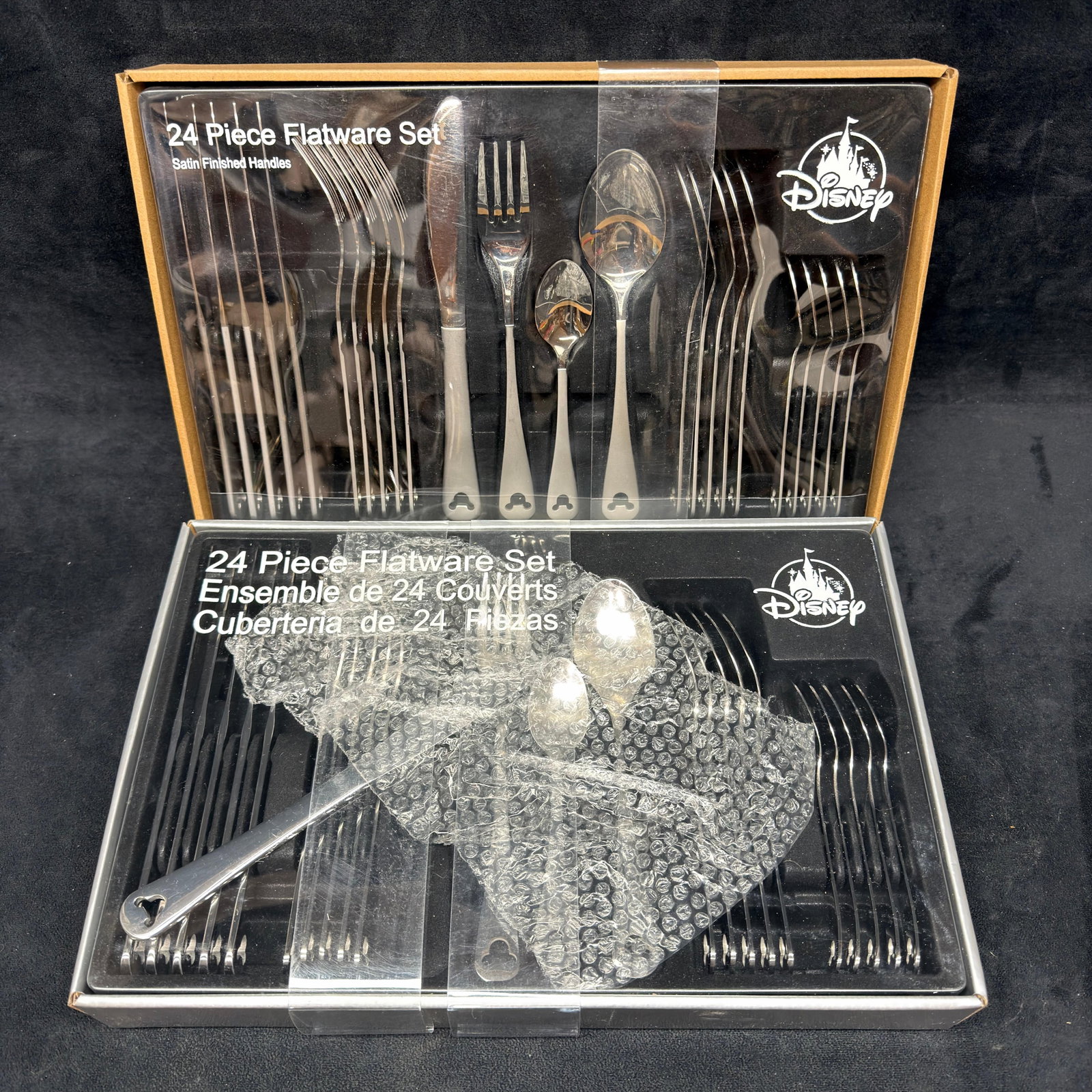 Disney Mickey Mouse Icon Flatware Set 24 Piece Two: Two 24-piece flatware sets featuring the Mickey Mouse icon. These items are in like-new, previously stored condition with wear and surface scratches/markings. Please refer to all photos for full