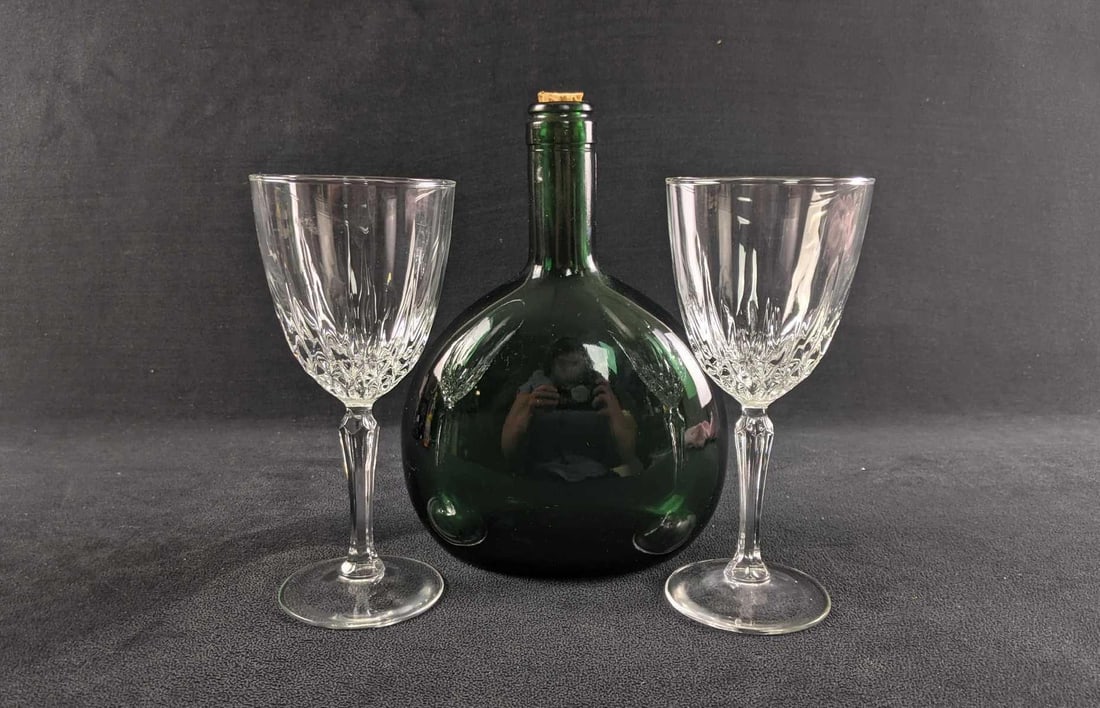 Vintage Wine Glasses and Green Bottle: Vintage Wine Glasses and Green Bottle. This lot includes: (2) Wine Glasses. These are not marked, but they appear to be "Cristal D'Arques-Durand Diamant" glass wine glasses. Each is approx