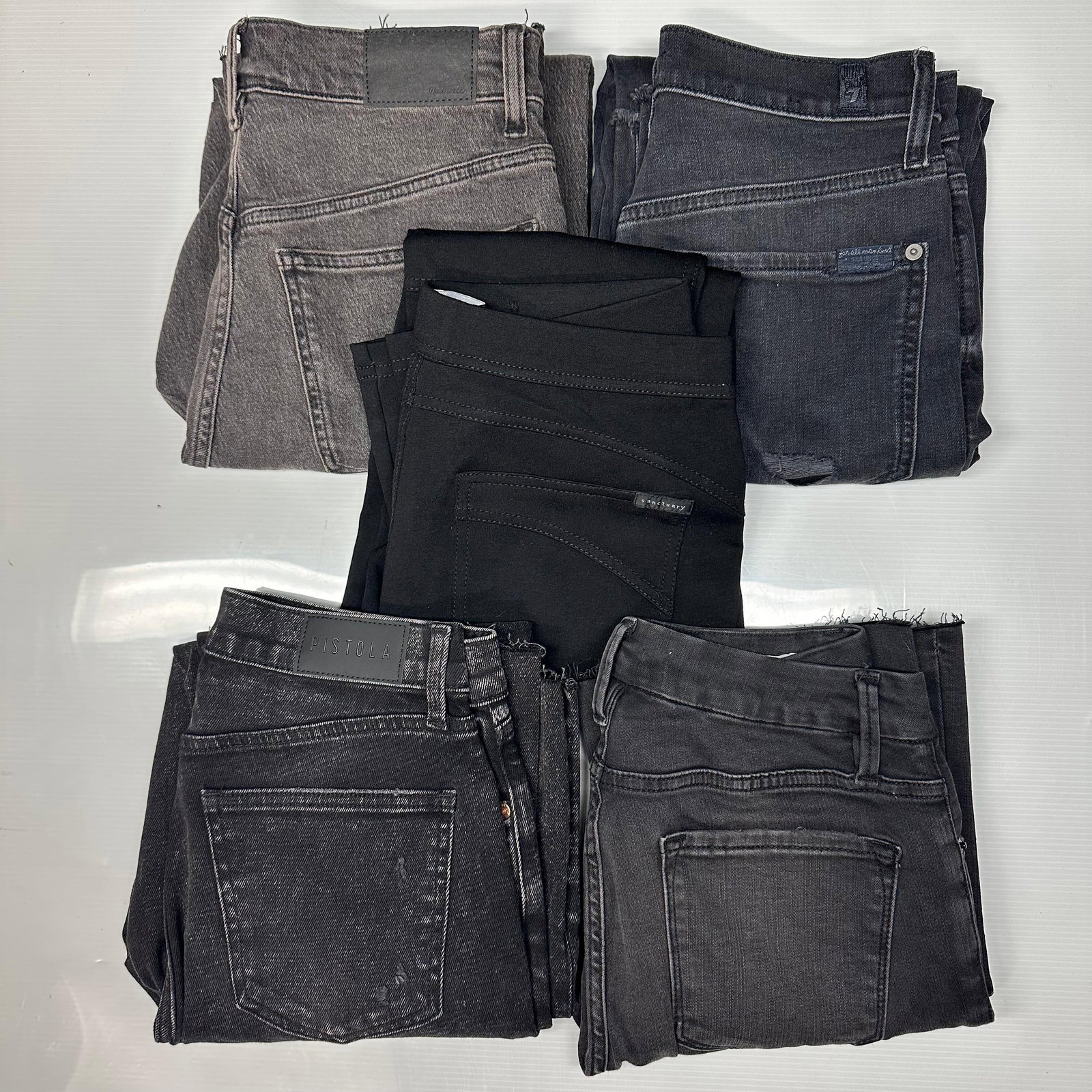 Lot of 5 Women Designer Denim and Pants Pistola Sanctuary 7 For All Mankind: Group of five women’s pants and jeans in dark and neutral tones. This lot includes recognizable contemporary brands such as Pistola and Sanctuary, along with additional comparable designer denim