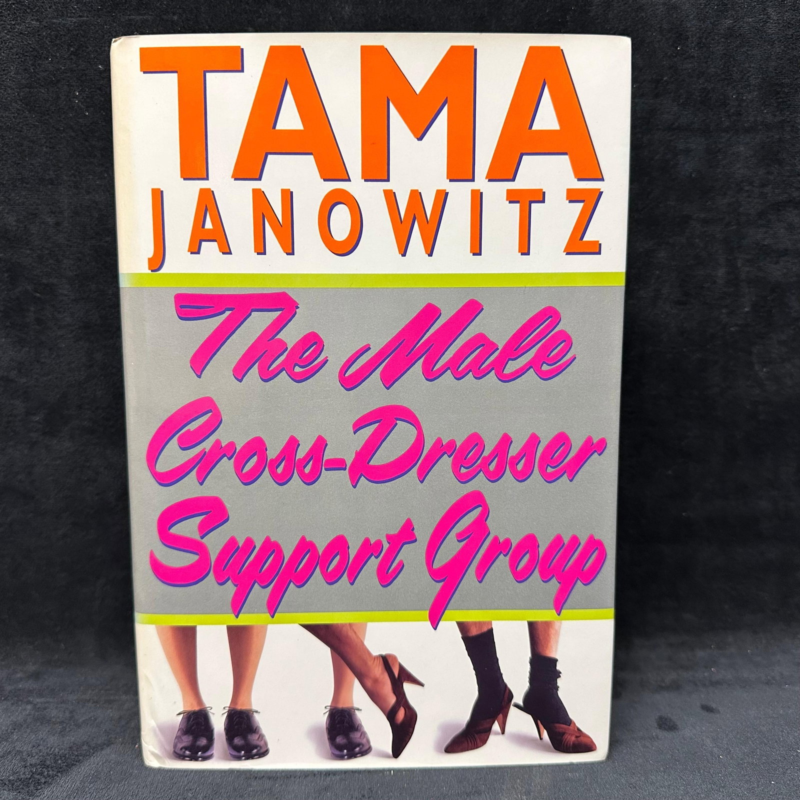 The Male Cross Dresser Support Group Tama Janowitz Signed Hardcover Book: Signed with a personal inscription to Michel Roux. Condition shows general handling wear, scuffing, and surface marks to the cover consistent with age. Interior pages appear intact. Includes dust jack