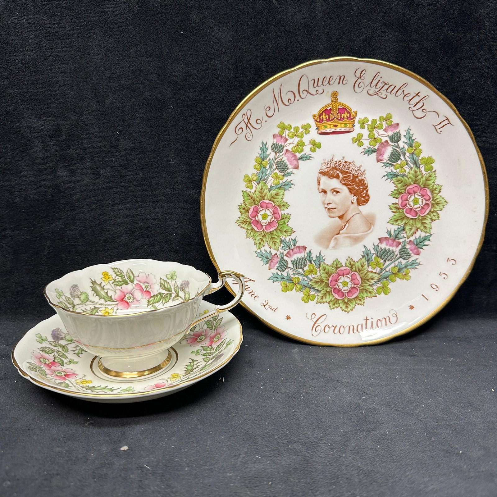 Queen Elizabeth II Coronation Commemorative Plate with Paragon Teacup and Saucer: Group lot featuring a 1953 Queen Elizabeth II Coronation commemorative display plate together with a matching Paragon fine bone china teacup and saucer. Marks to the underside indicate English manufac
