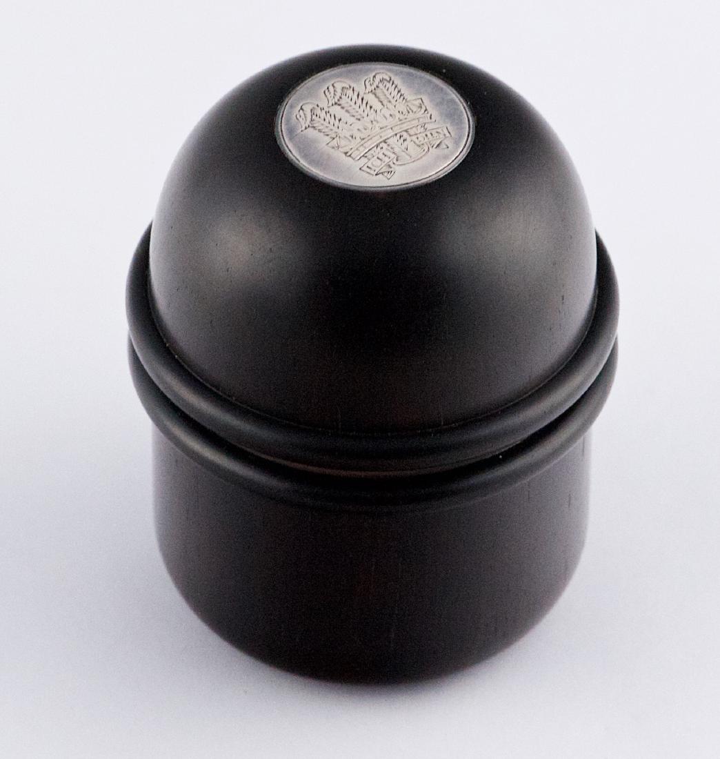 Benney, Adrian Gerald Sallis (1930-2008) Small ebony: Beautiful ebony wooden small round box inlaid on top with a 3/4" round silver seal of the HRH Prince of Wales, including the original box of Gerald Benney 3" x 2" x 2"; 7.62 x 5.08 x 5.08 cm Provenanc