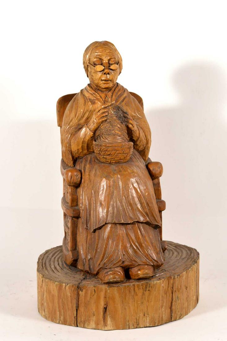 Douvil, M. - Grand-mère au tricot - 1971: Douvil, M. (XX) Grand-mère au tricot (1971) Description: Wooden sculpture, signed on lower right M. Douvil Dimension (PO): 26" x 17" x 11" Dimension (CM): 67 x 43.2 x 28 cm Condi