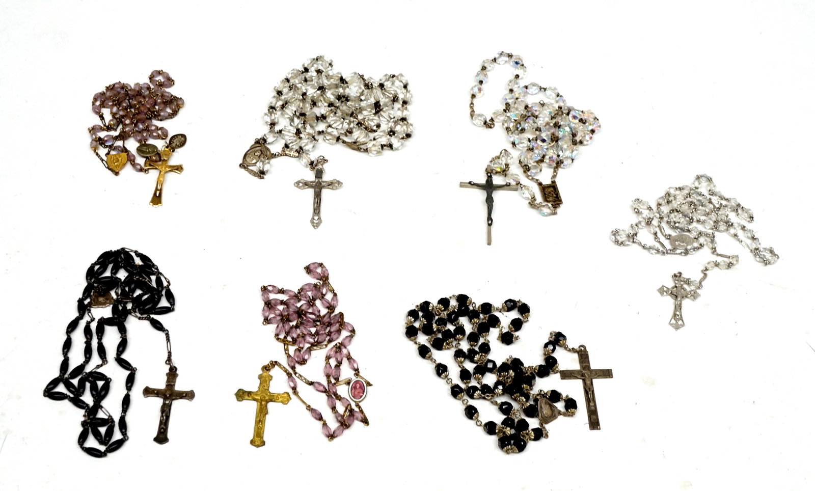7 different rosaries with beads, cross adorned with Christ: 7 chapelets différents avec des billes, croix ornée du Christ L'une est plaquée or, et les autres ont des perles de matières différentes. Rapport de condition: bonne