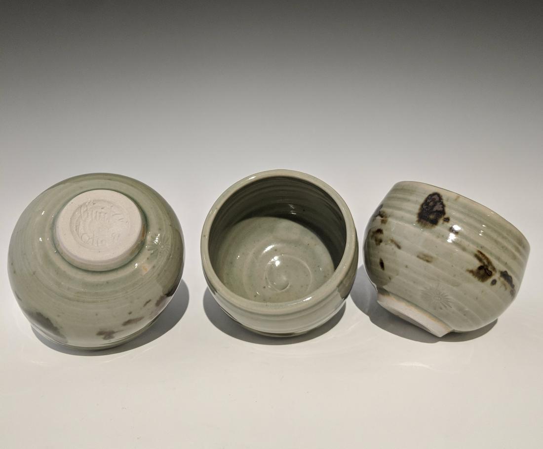 Otto and Vivika Heino - Three small bowls: Lot 116 Otto and Vivika Heino - Three small bowls American (20th century) Three small bowls (1991) porcelain, celadon glaze with tenmuko details signed on bottom 3 x 3 1/4 inches each Provenance: from